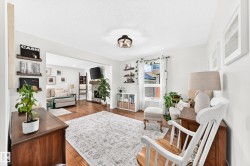 Open-concept living space featuring wood-finish flooring, recessed lighting, and a neutral color palette - 