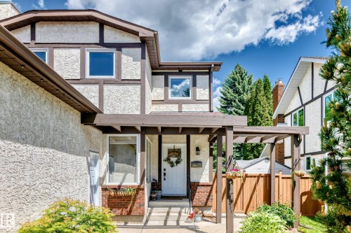 Tudor-style exterior with stucco siding and dark brown trim accents - 15146 Ramsay Crescent, Edmonton, AB 