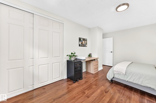 Room featuring wood-finish flooring, white walls, and a ceiling-mounted light fixture - 15146 Ramsay Crescent, Edmonton, AB 