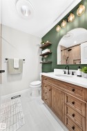 Bathroom featuring a wood-finish vanity with a white countertop and integrated sink - 