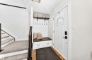 Entryway featuring a built-in bench with storage drawers, shiplap accent wall, and integrated coat hooks - 15146 Ramsay Crescent, Edmonton, AB 
