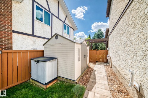 Path with paver stone surfacing, flanked by wood chip landscaping - 15146 Ramsay Crescent, Edmonton, AB 