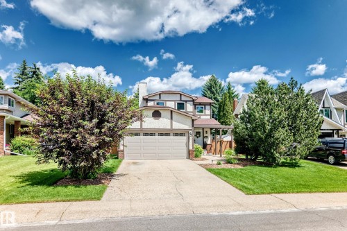 Exterior featuring a two-car garage, concrete driveway, and front lawn - 15146 Ramsay Crescent, Edmonton, AB 