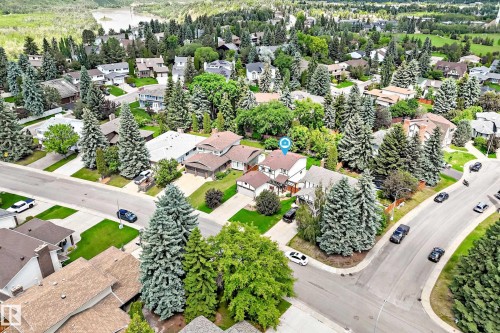 Residential property with a light-colored exterior and a brown shingle roof, situated on a corner lot - 15146 Ramsay Crescent, Edmonton, AB 