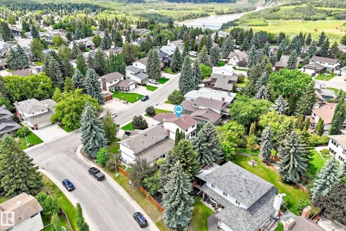 Residential neighborhood featuring mature trees, paved streets, and a river in the distance - 15146 Ramsay Crescent, Edmonton, AB 