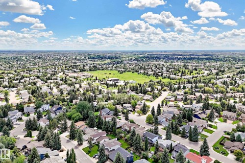 Expansive aerial view showcasing a residential area with varied housing styles and mature trees - 15146 Ramsay Crescent, Edmonton, AB 