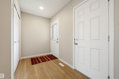 Entryway featuring light-toned walls, wood-finish flooring, and white trim - 56 Springbrook Wynd, Spruce Grove, AB - Indoor Photo Showing Other Room