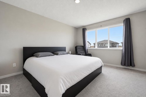 Bedroom featuring light gray wall paint and complementary gray carpet flooring - 56 Springbrook Wynd, Spruce Grove, AB - Indoor Photo Showing Bedroom