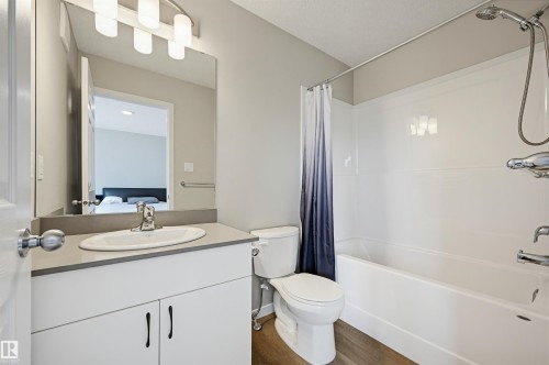 Contemporary bathroom featuring a white vanity with a gray countertop, an oval undermount sink, and chrome fixtures - 56 Springbrook Wynd, Spruce Grove, AB - Indoor Photo Showing Bathroom