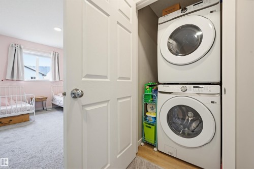 Dedicated laundry closet featuring a stacked washer and dryer - 56 Springbrook Wynd, Spruce Grove, AB - Indoor Photo Showing Laundry Room