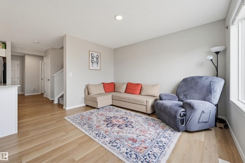 Open-concept living area featuring light wood-finish flooring, recessed lighting, and ample natural light from a large window - 56 Springbrook Wynd, Spruce Grove, AB - Indoor Photo Showing Living Room