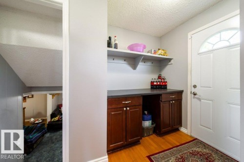West door out to back yard with built in cabinetry - 4823 10 Avenue, Edmonton, AB 