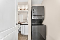 Compact laundry area featuring a stacked washer and dryer - 