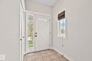 Entryway featuring a white paneled door with decorative glass, sidelights, and transom window - 39 Meadowview Court, Spruce Grove, AB 