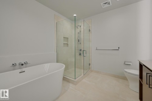 Freestanding soaking tub with wall-mounted fixtures - #3901 10360 102 St Nw Nw, Edmonton, AB - Indoor Photo Showing Bathroom