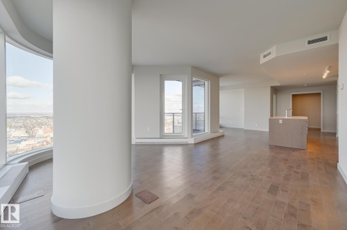 Spacious open-concept interior featuring wood-finish flooring - #3901 10360 102 St Nw Nw, Edmonton, AB - Indoor