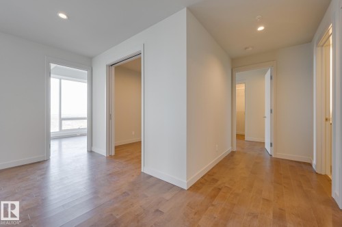 Open interior showcasing wood-finish flooring, recessed lighting, white walls, and white trim - #3901 10360 102 St Nw Nw, Edmonton, AB - Indoor Photo Showing Other Room