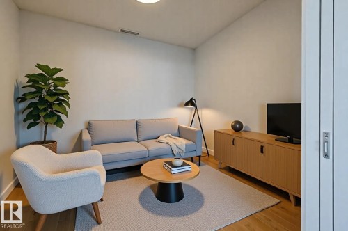 Bright living area featuring wood-finish flooring, light-toned walls, and a recessed ceiling light - #3901 10360 102 St Nw Nw, Edmonton, AB - Indoor