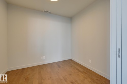 Room featuring wood-finish flooring, white baseboards, light-toned walls, and a recessed ceiling light - #3901 10360 102 St Nw Nw, Edmonton, AB - Indoor Photo Showing Other Room