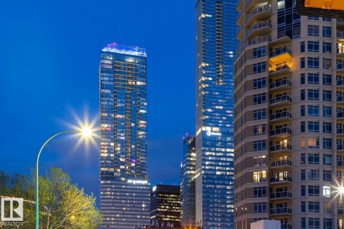Modern high-rise residential building featuring multiple stories of balconies and large window openings - #3901 10360 102 St Nw Nw, Edmonton, AB -  With Facade