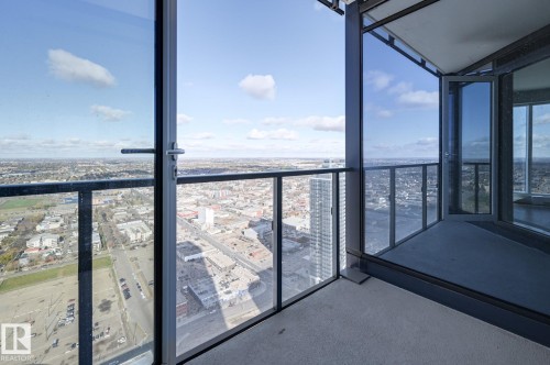 Private balcony featuring a concrete floor, glass railing, and floor-to-ceiling windows - #3901 10360 102 St Nw Nw, Edmonton, AB -  With View With Exterior