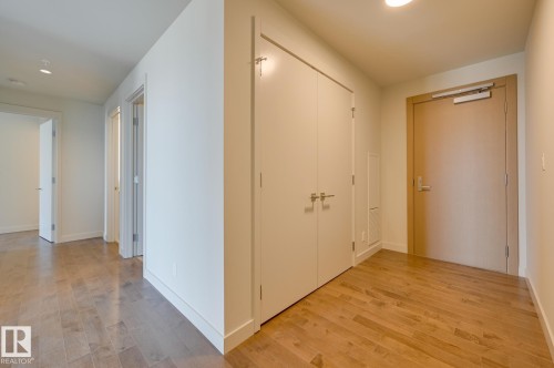 Modern hallway featuring wood-finish flooring, recessed lighting, and a neutral color palette - #3901 10360 102 St Nw Nw, Edmonton, AB - Indoor Photo Showing Other Room