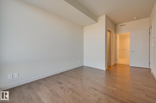 Spacious room featuring wood-finish flooring, light-toned walls, and recessed lighting - #3901 10360 102 St Nw Nw, Edmonton, AB - Indoor Photo Showing Other Room