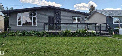 Contemporary exterior featuring horizontal siding, an angled roofline, and a prominent stone veneer accent - 10523 105 Street, Westlock, AB 