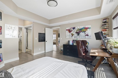 Spacious interior featuring light wood-finish flooring, neutral wall tones, and recessed lighting - #206 10232 115 St Nw, Edmonton, AB 