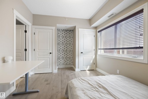 Bright interior room with light wood-finish flooring - #206 10232 115 St Nw, Edmonton, AB 