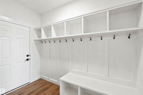 Built-in entryway storage system featuring a bench, individual cubbies, and coat hooks - 2232 5 Avenue, Edmonton, AB 