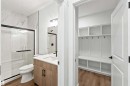 Full bathroom featuring a walk-in shower with a black-framed glass enclosure and a vanity with a white countertop - 2232 5 Avenue, Edmonton, AB 