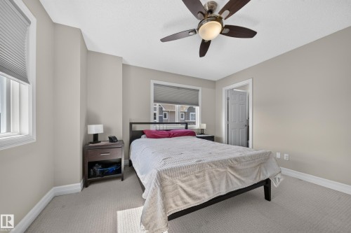 Carpeted bedroom with neutral wall paint and white trim - 64 655 Tamarack Road, Edmonton, AB 