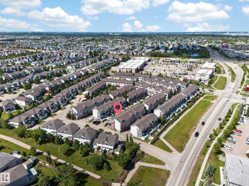Aerial view of a residential community featuring rows of townhouses and single-family homes - 64 655 Tamarack Road, Edmonton, AB 