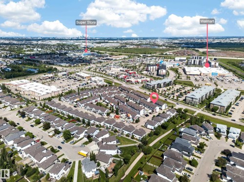 Aerial perspective showcasing a residential area and surrounding commercial developments - 64 655 Tamarack Road, Edmonton, AB 