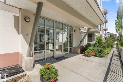 Contemporary building entrance featuring glass double doors - 408 11140 68 Avenue, Edmonton, AB 