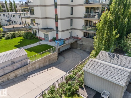 Multi-level building with individual balconies featuring glass railings - 408 11140 68 Avenue, Edmonton, AB 