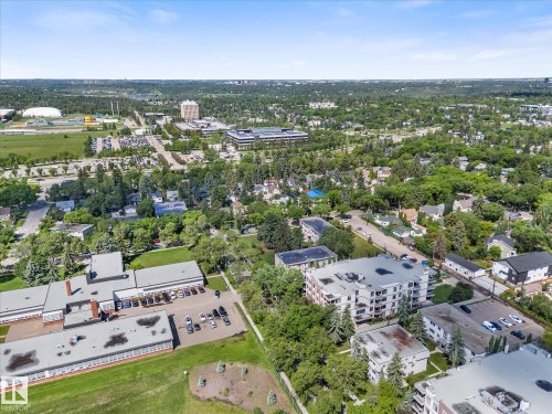 Expansive aerial perspective showcasing a developed urban landscape with diverse residential and commercial structures - 408 11140 68 Avenue, Edmonton, AB 