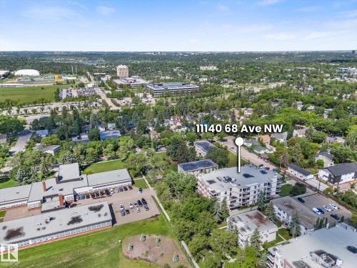 Aerial perspective highlighting a multi-story building within a treed urban setting - 408 11140 68 Avenue, Edmonton, AB 