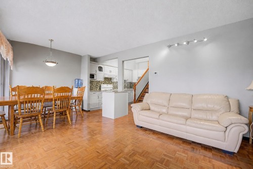Parquet wood-finish flooring extends throughout this open-concept room - 10242 161 Street, Edmonton, AB 