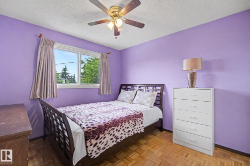 Hardwood parquet flooring frames this room featuring a ceiling fan with integrated lighting - 10242 161 Street, Edmonton, AB 
