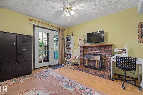 Living area with wood-finish flooring and a ceiling fan - 10242 161 Street, Edmonton, AB 