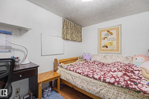 Wood-finish flooring with light-toned walls and a patterned ceiling - 10242 161 Street, Edmonton, AB 
