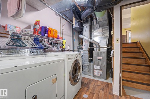 Dedicated laundry area featuring a front-loading washing machine and a top-loading dryer - 10242 161 Street, Edmonton, AB 