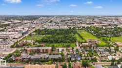 Expansive urban landscape featuring a mix of residential and commercial properties, mature tree cover, and developed infrastructure - 