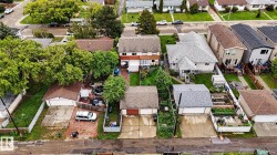 Detached single-family home with a gabled roof and light gray shingles - 