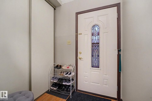 Entryway featuring a white paneled door with a stained glass insert and dark trim - 10242 161 Street, Edmonton, AB 