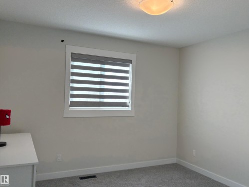 Neutral wall tones with crisp white baseboards and window trim - 9952 227 Street, Edmonton, AB 