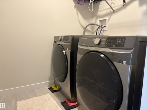 Dedicated laundry area featuring tile flooring and neutral wall tones - 9952 227 Street, Edmonton, AB 