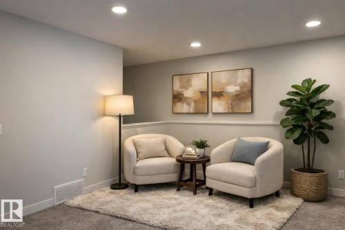 Virtually staged. Recessed ceiling lighting illuminates a room featuring light gray walls, a chair rail, and carpeting - 9952 227 Street, Edmonton, AB 